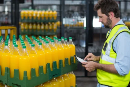 U.S. softdrink manufacturing factory showing a worker who are maintaining record of juice bottles