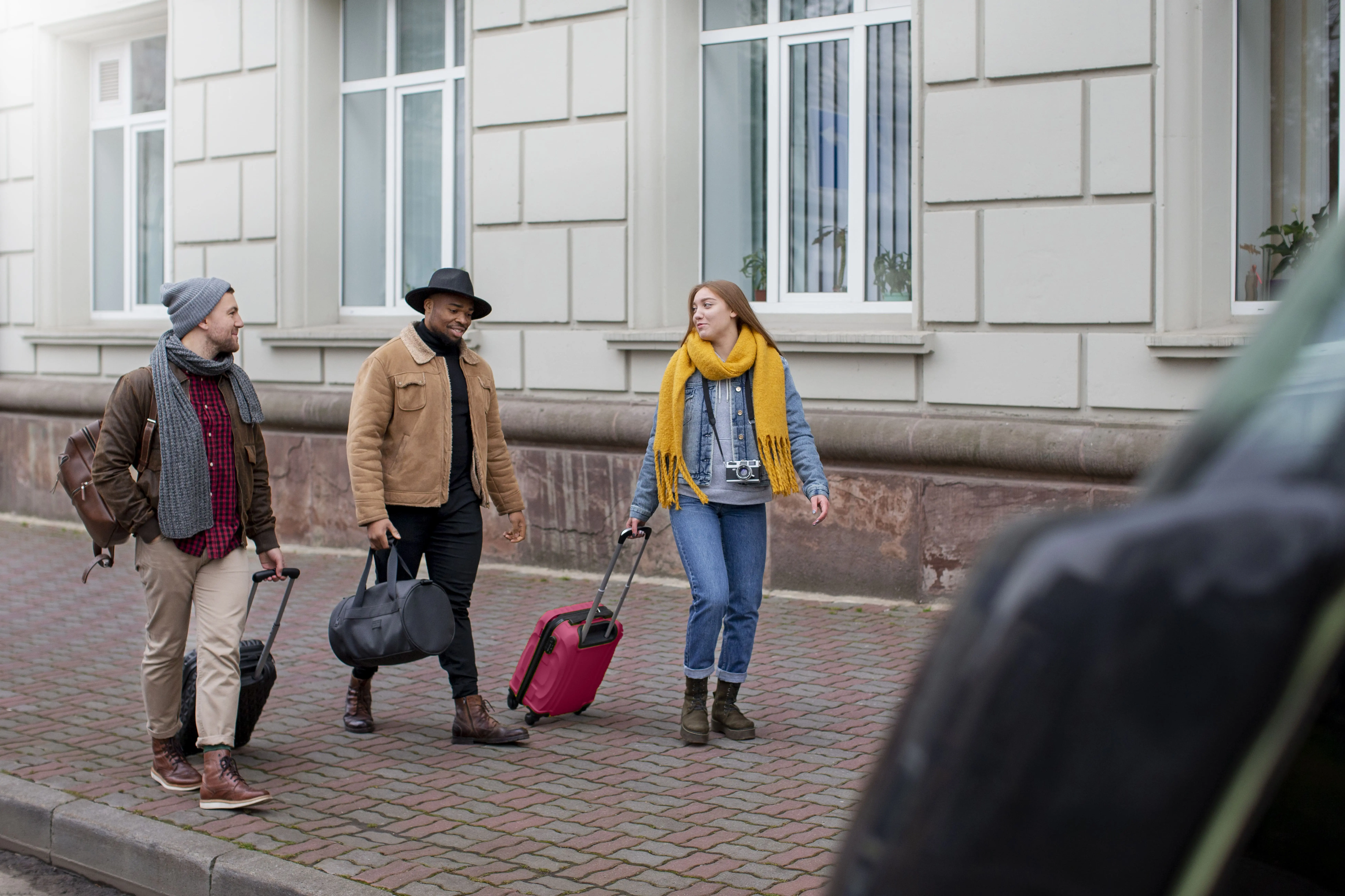 young adults travelling with their luggages
