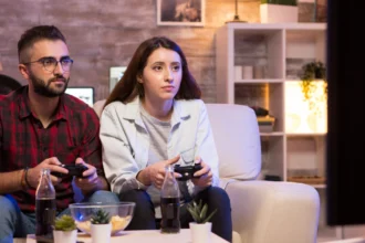 a couple enjoying video games with gaming consoles
