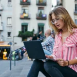 young UK based woman working on laptop